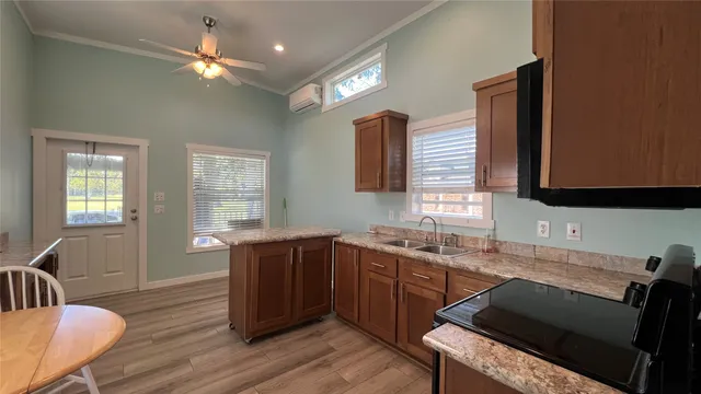 a kitchen with a sink cabinets and wooden floor