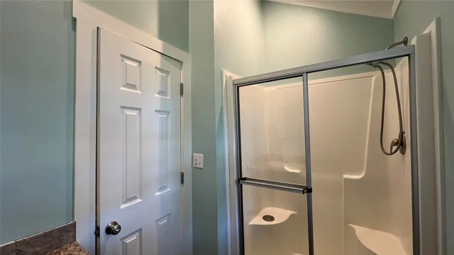 a bathroom with a glass shower door