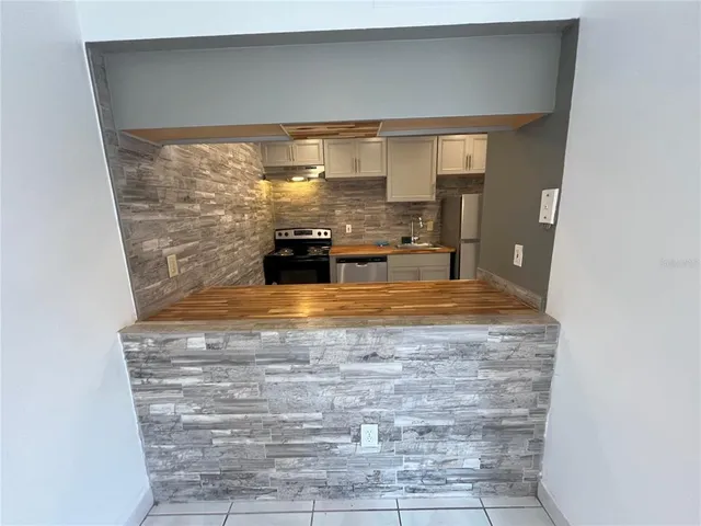 a view of a living room with a fireplace