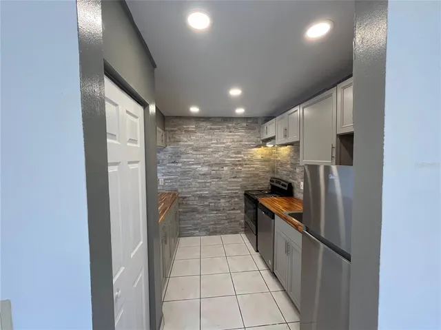 a kitchen with stainless steel appliances a refrigerator and a sink
