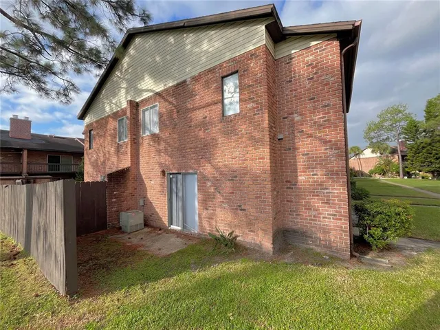 a view of a brick house with a yard