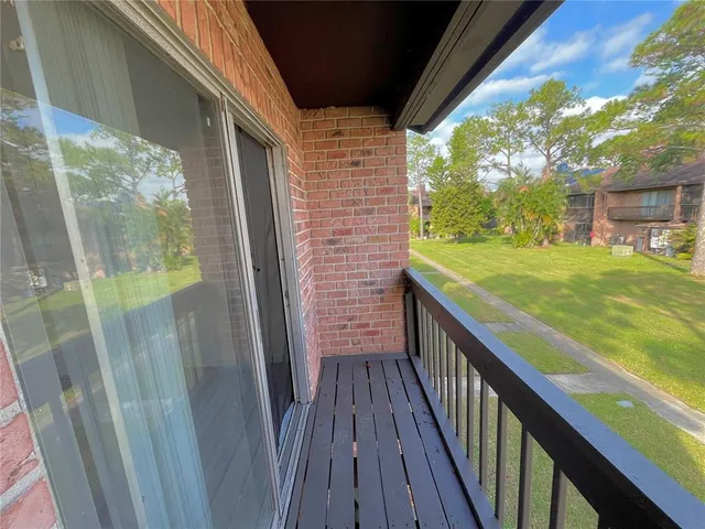 a view of balcony with wooden floor