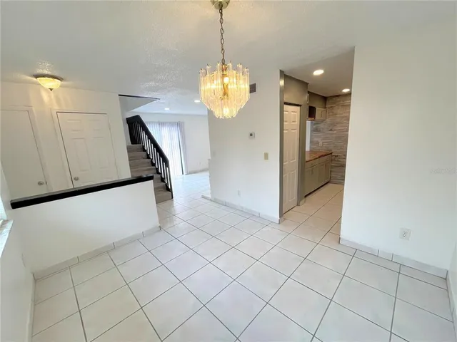 a view of a kitchen with cabinet and a chandelier
