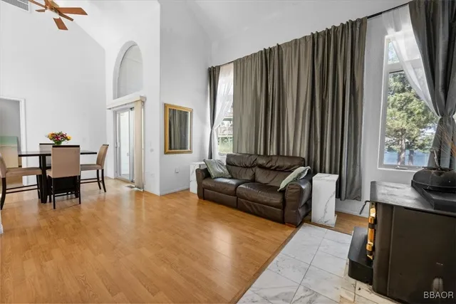 a living room with furniture and large windows