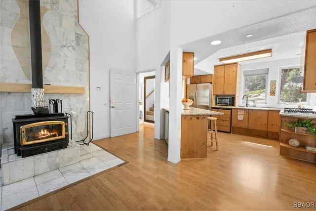 a kitchen with stainless steel appliances granite countertop a stove a sink and a refrigerator