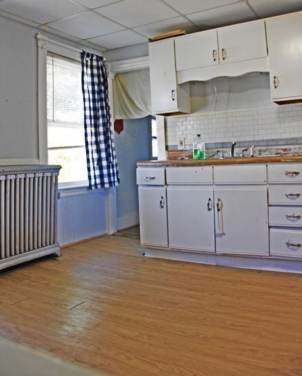 64 High Street Gardner, MA 01440 - Photo 12 of 20 a kitchen with stainless steel appliances granite countertop a stove a sink and white cabinets