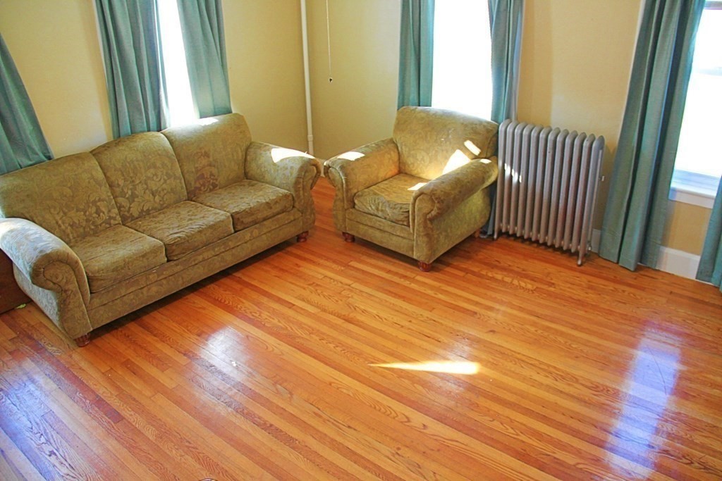 64 High Street Gardner, MA 01440 - Photo 4 of 20 a living room with couches and painted walls with wooden floor