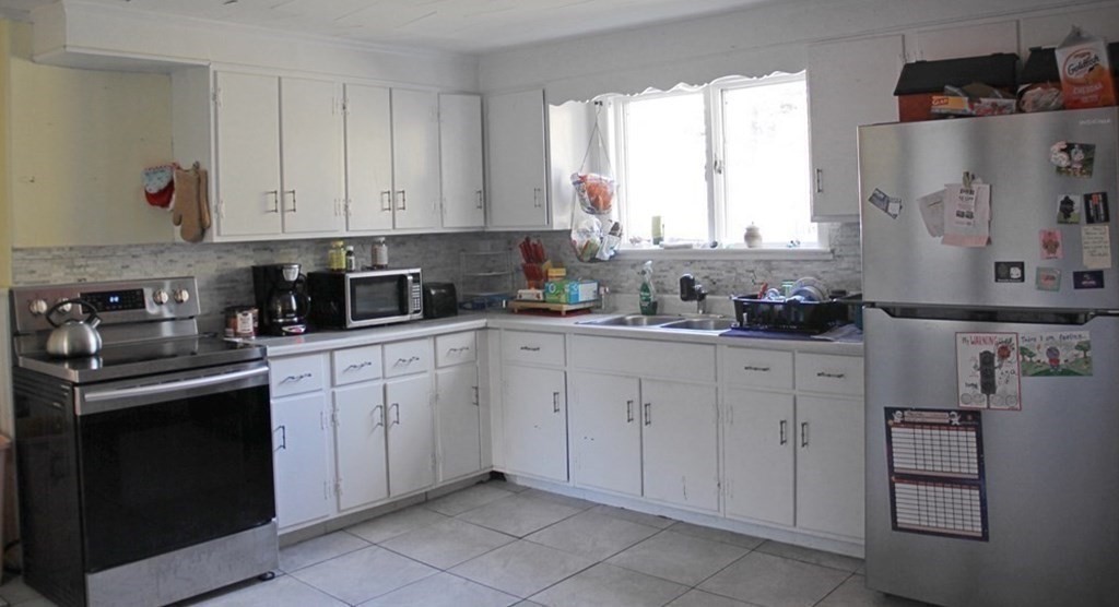 64 High Street Gardner, MA 01440 - Photo 5 of 20 a kitchen with cabinets appliances a sink and a window
