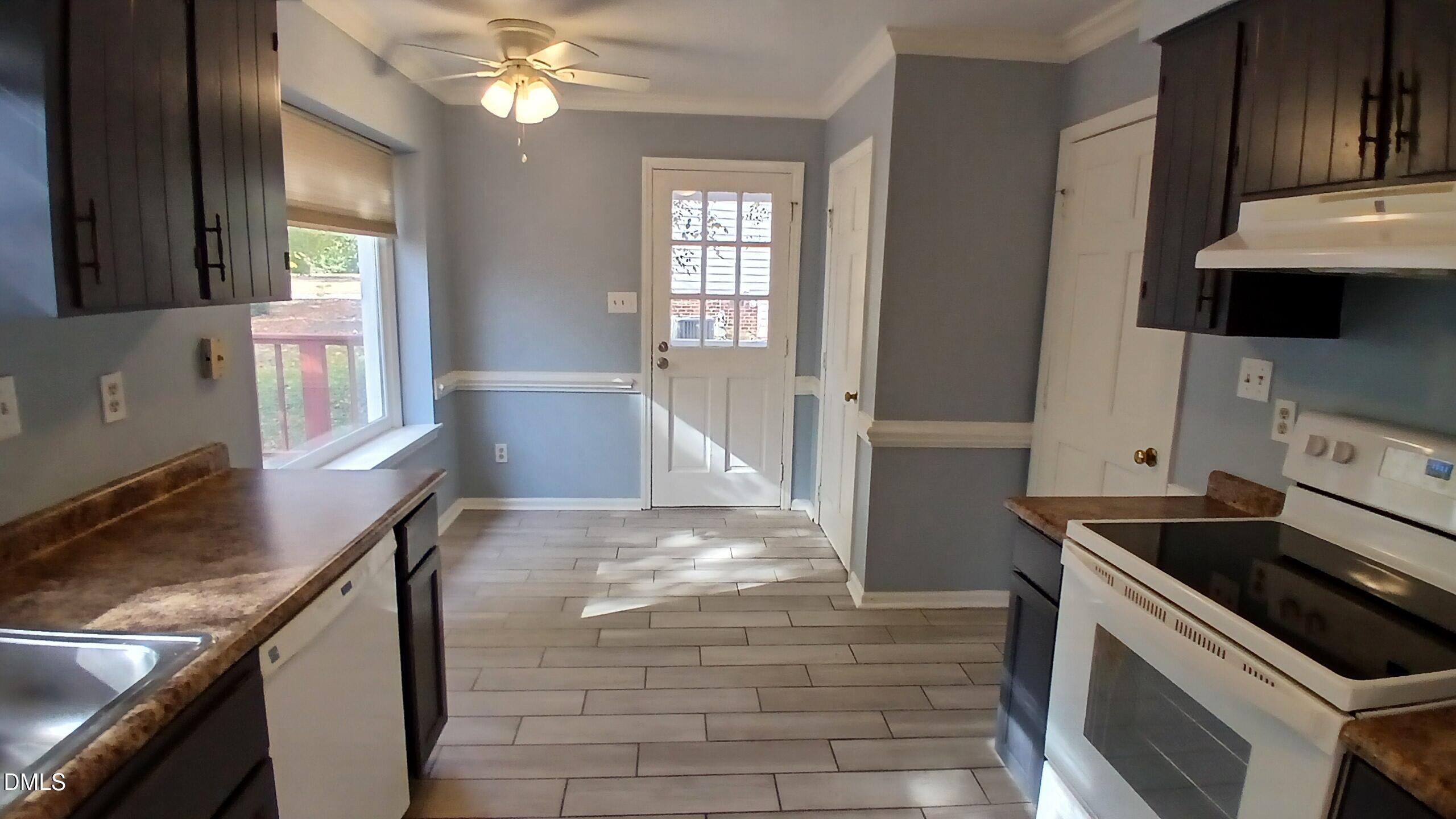 3504 East Jameson Road Raleigh, NC 27604 - Photo 11 of 35 a kitchen with a sink stove top oven and cabinets
