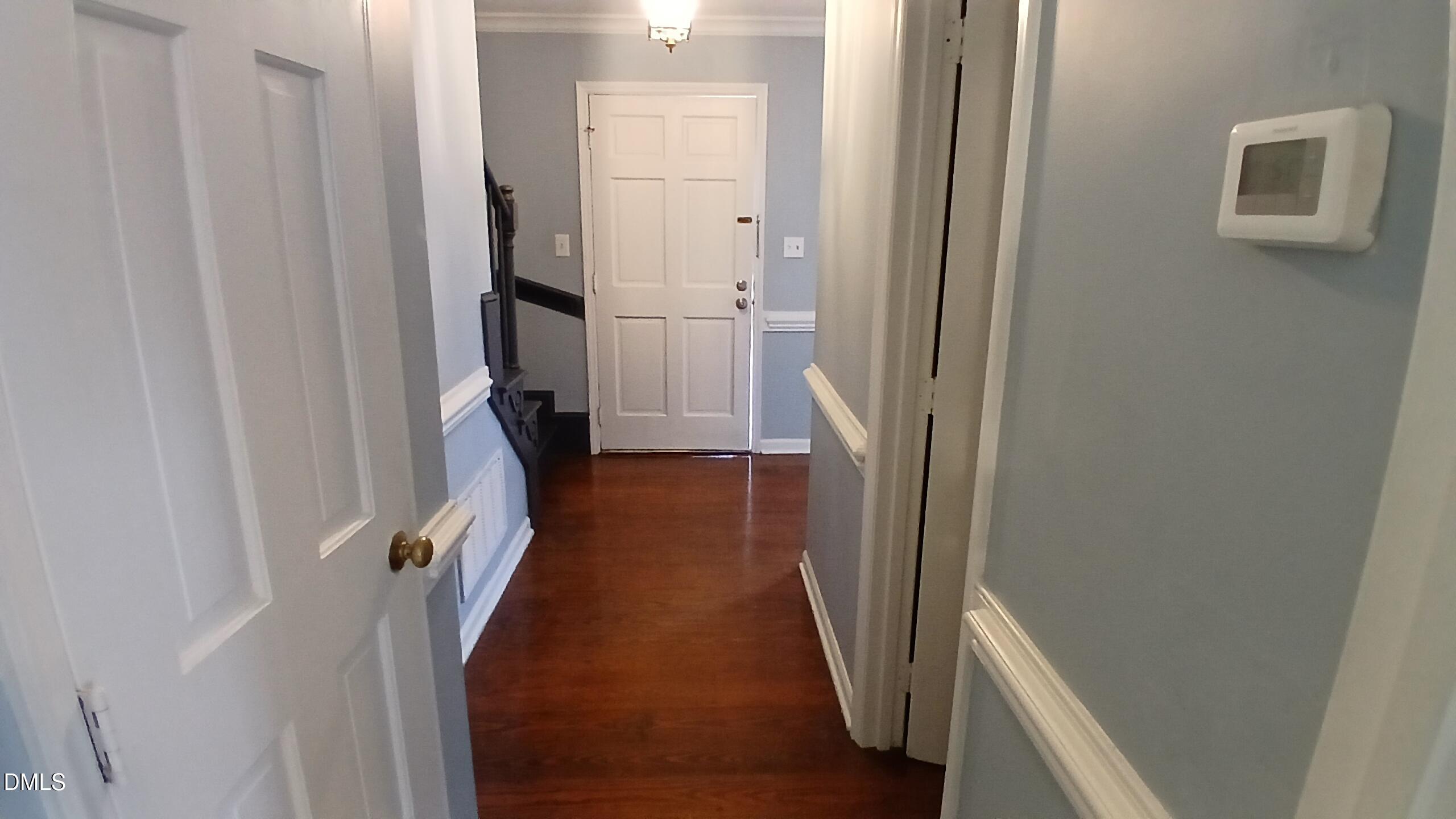 3504 East Jameson Road Raleigh, NC 27604 - Photo 13 of 35 a view of a hallway with wooden floor and staircase