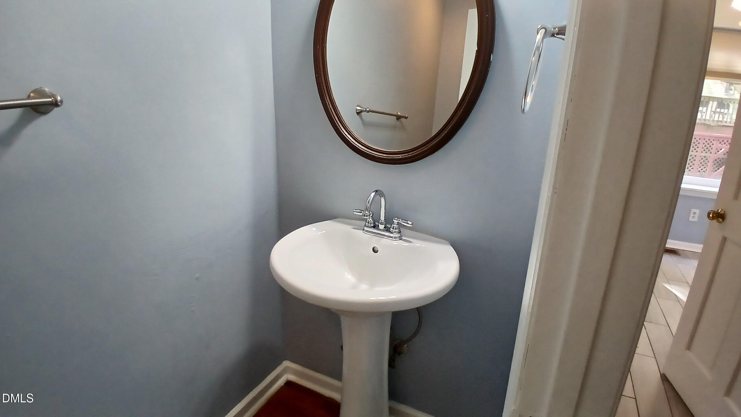 3504 East Jameson Road Raleigh, NC 27604 - Photo 15 of 35 a bathroom with a sink a mirror and a window