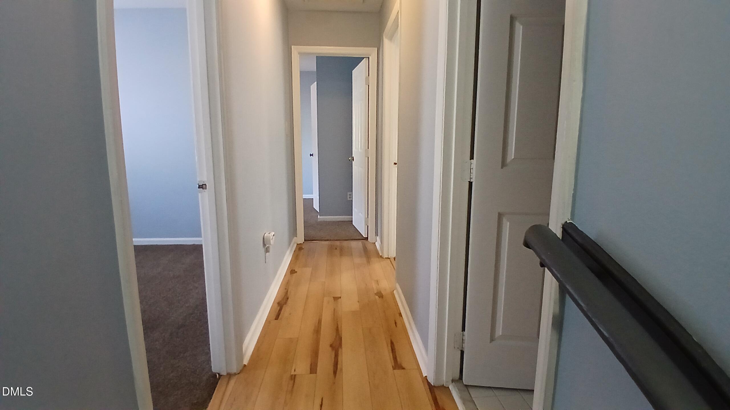 3504 East Jameson Road Raleigh, NC 27604 - Photo 17 of 35 a view of a hallway with wooden floor and staircase