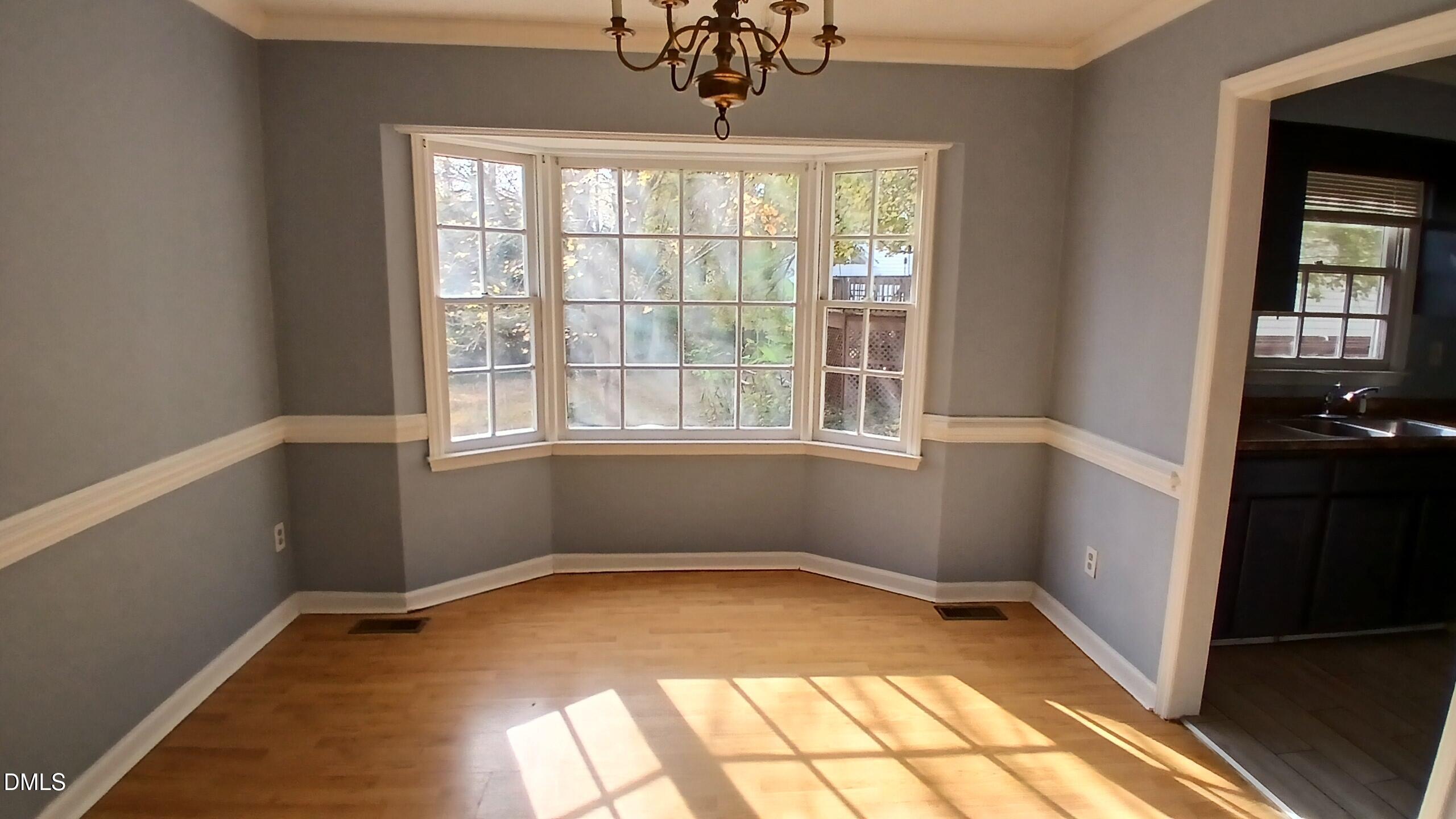 3504 East Jameson Road Raleigh, NC 27604 - Photo 8 of 35 a view of empty room with wooden floor and fan