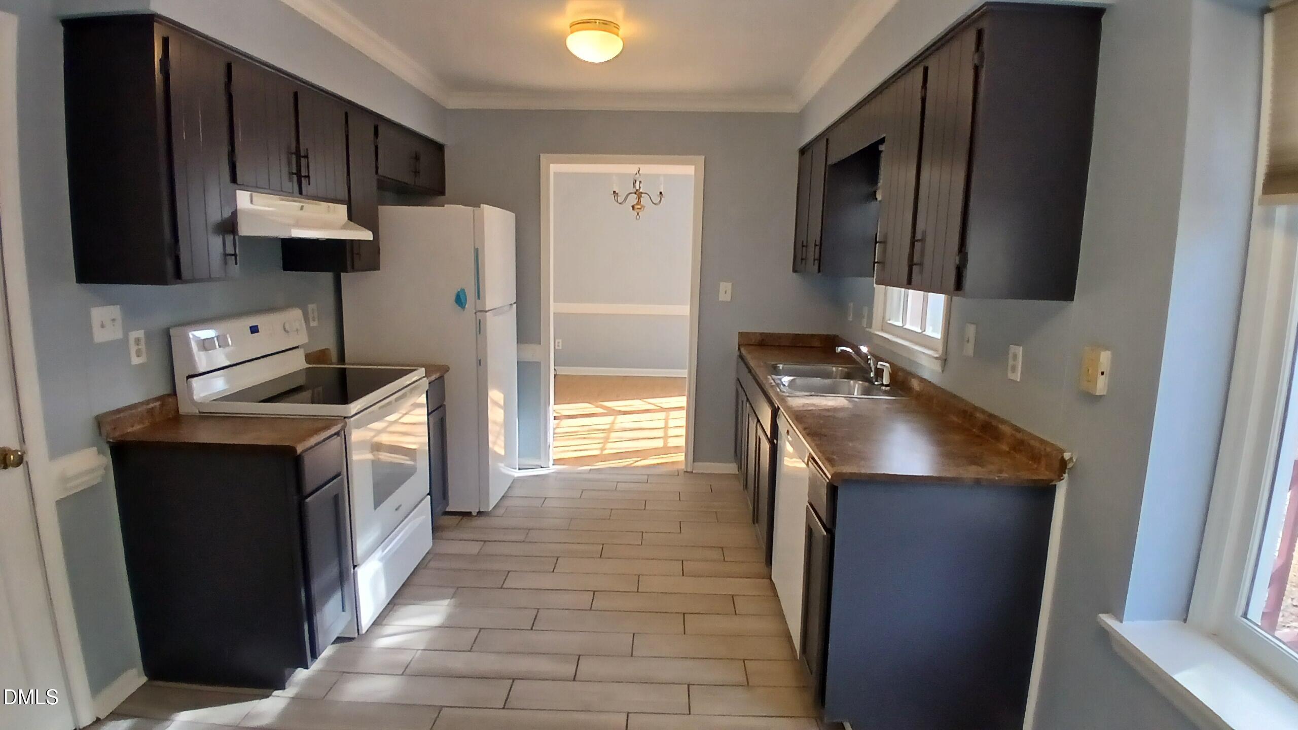 3504 East Jameson Road Raleigh, NC 27604 - Photo 10 of 35 a kitchen with stainless steel appliances granite countertop a refrigerator a stove a sink and a microwave