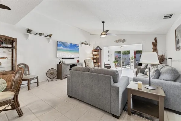 a bedroom with bed and a flat tv screen on dresser