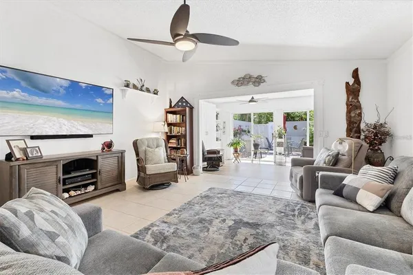 a bedroom with a bed and a refrigerator