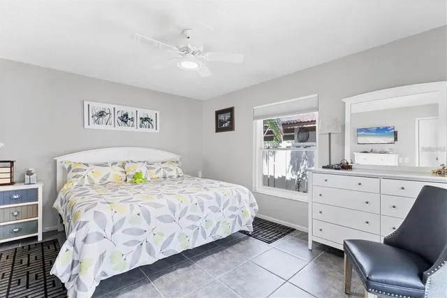 a living room with furniture potted plant and a large window