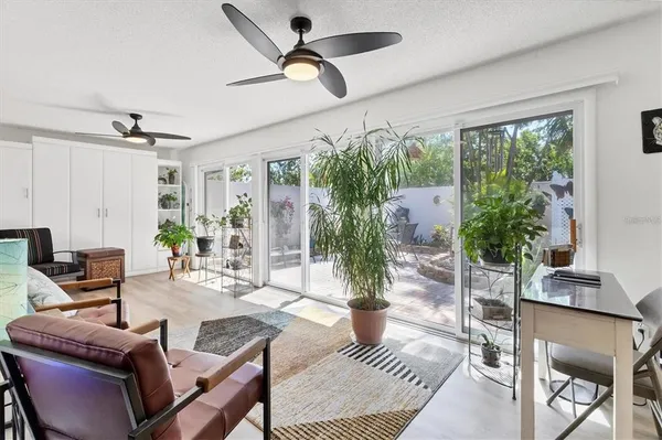 a view of a patio with table and chairs and potted plants