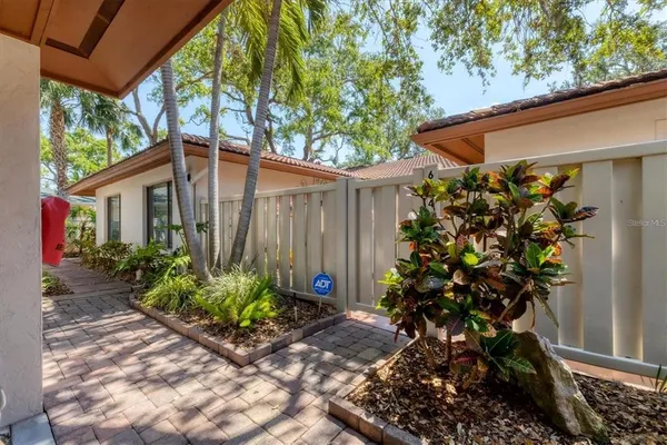 a backyard of a house with flower plants