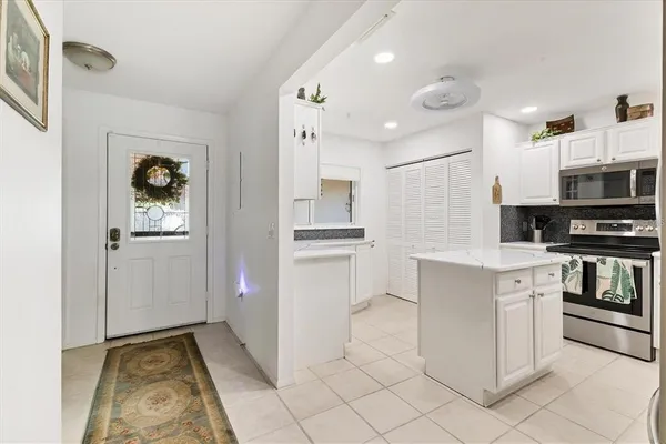 a kitchen with stainless steel appliances granite countertop a sink and a stove