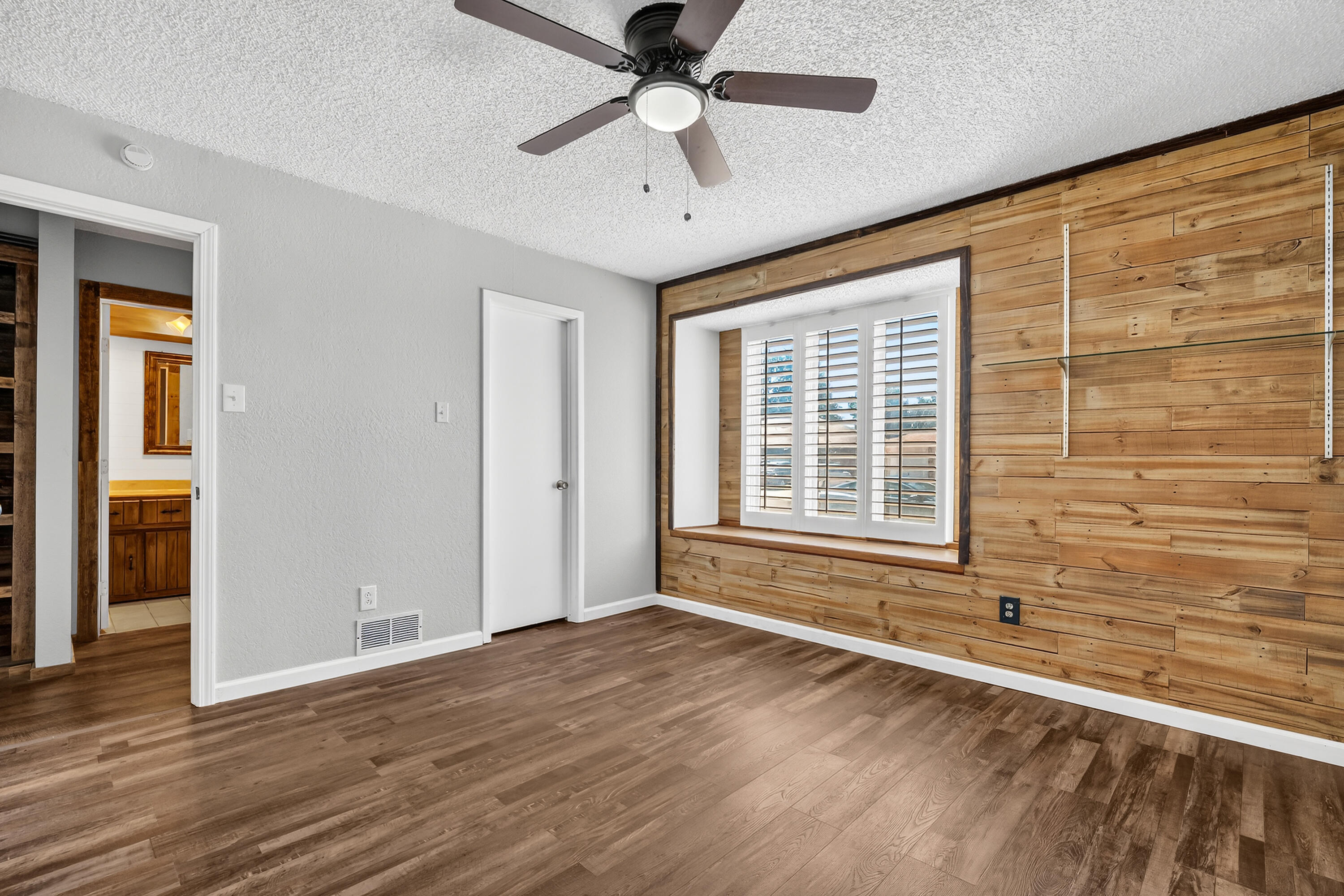 5236 91st Street Lubbock, TX 79424 - Photo 19 of 23 a view of an empty room with a window and wooden floor