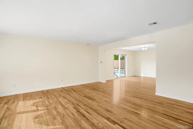 a view of an empty room and wooden floor