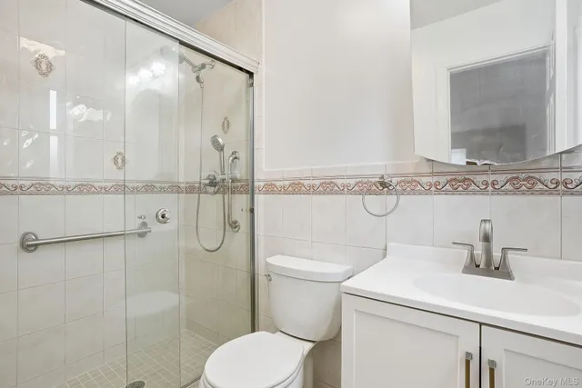 a bathroom with a toilet sink and shower