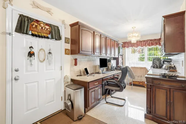a view of kitchen with stainless steel appliances granite countertop a stove and a refrigerator
