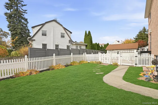 a view of a house with a yard and deck
