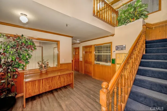 a view of a couches with wooden floor and stairs