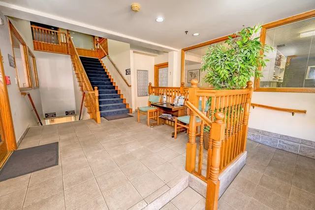a view of a livingroom with furniture and stairs