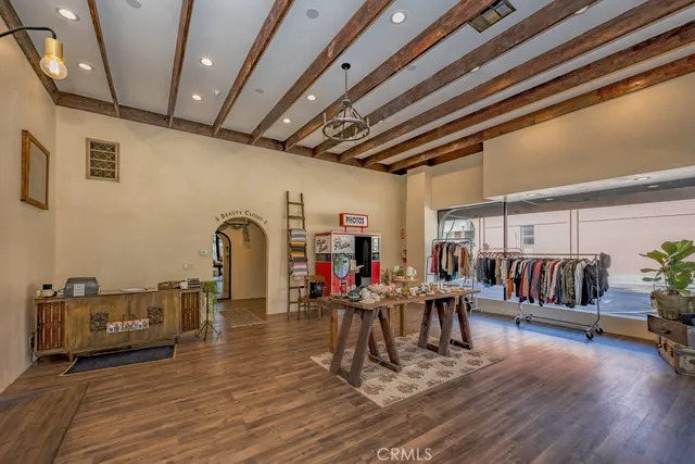 a dining room with furniture floor to ceiling window and potted plants