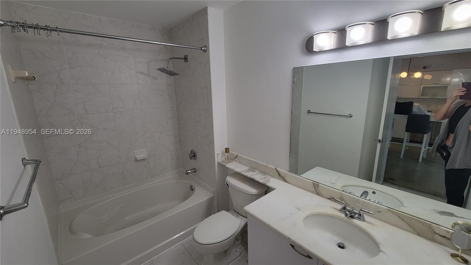 234 Northeast 3rd Street, Unit 1209 Miami, FL 33132 - Photo 5 of 12 a bathroom with a sink toilet and shower