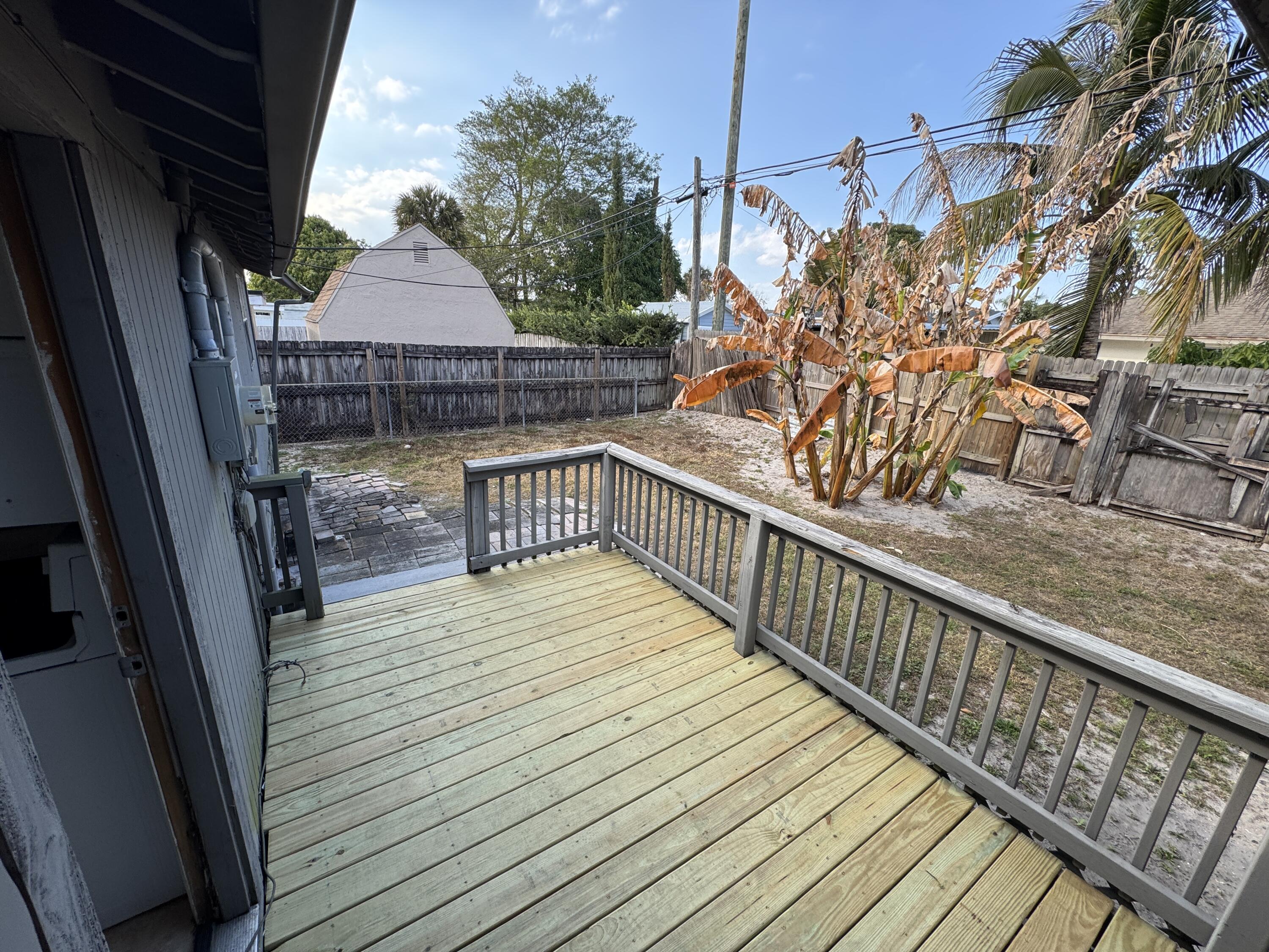5645 Papaya Road Royal Palm Estates, FL 33413 - Photo 17 of 23 a balcony with wooden floor and furniture
