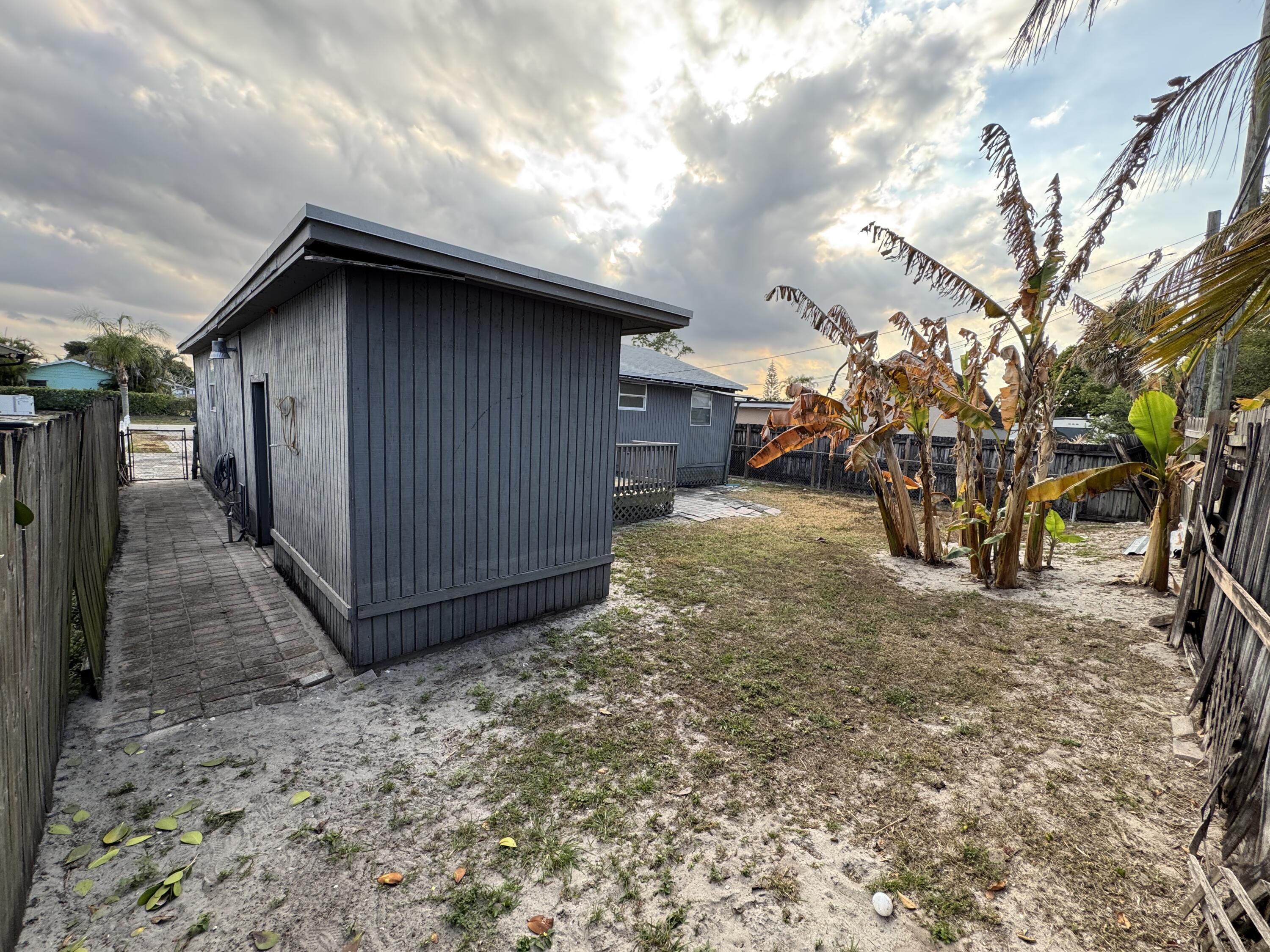 5645 Papaya Road Royal Palm Estates, FL 33413 - Photo 21 of 23 a view of a house with a yard