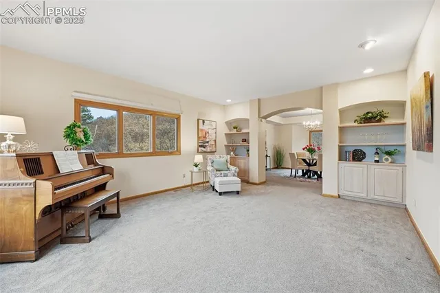 a view of a livingroom with furniture and a window
