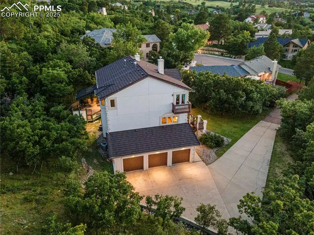 an aerial view of a house with swimming pool and garden