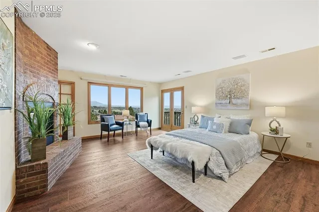 a bedroom with a bed furniture potted plant and a window
