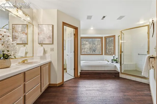 a bathroom with a double vanity sink a mirror and a bathtub