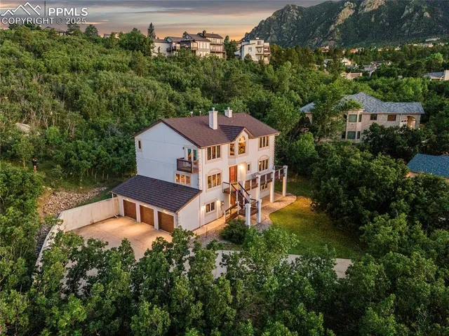 an aerial view of a house with swimming pool and garden