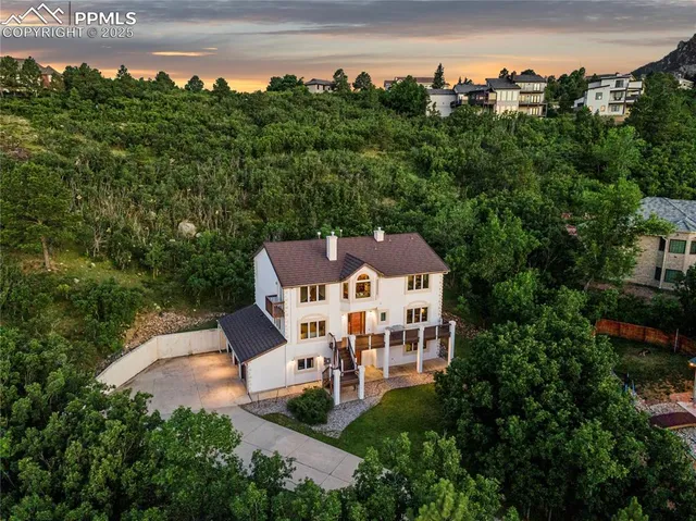 an aerial view of a house with a yard