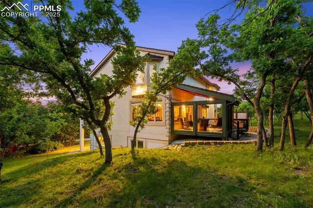 a backyard of a house with barbeque oven table and chairs