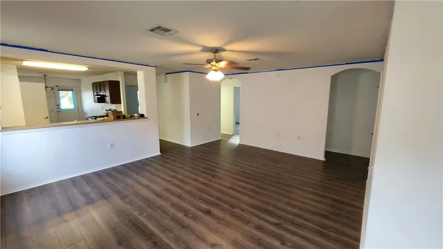 wooden floor in an empty room with a window