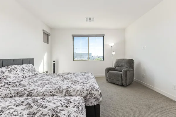 a bedroom with bed and window