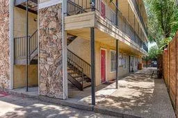 a view of a house with a tree in front of it