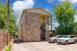 a car parked in front of a brick house