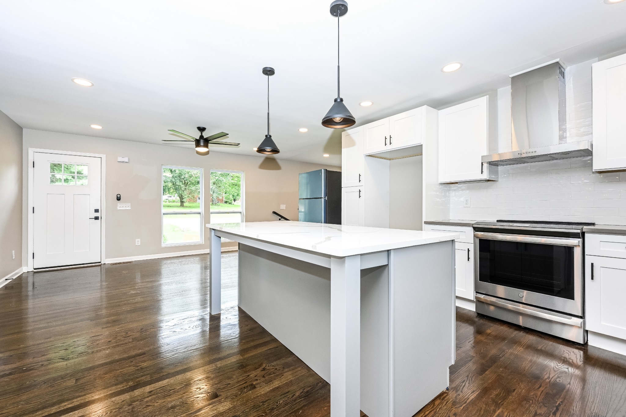 4932 Aquatic Road Nashville, TN 37211 - Photo 6 of 16 a kitchen with stainless steel appliances granite countertop a stove a sink a refrigerator a center island with wooden floor and cabinets