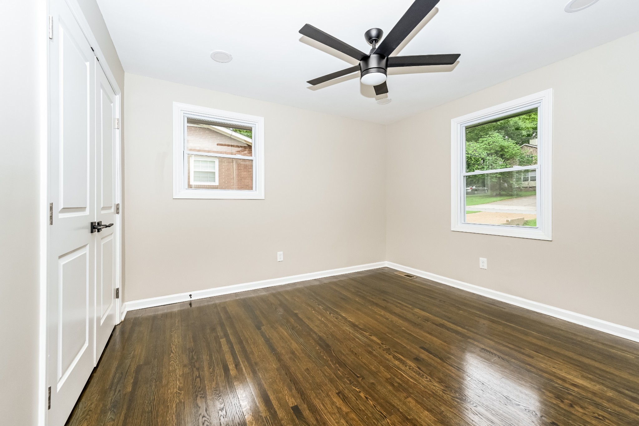4932 Aquatic Road Nashville, TN 37211 - Photo 10 of 16 an empty room with wooden floor and windows