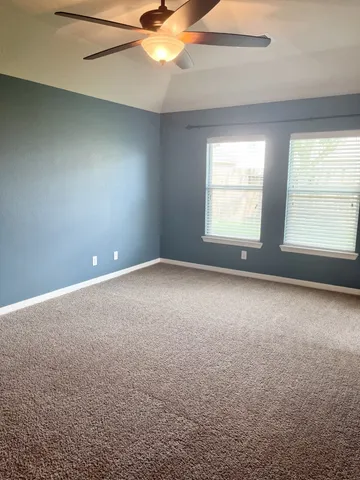 a spacious bathroom with a granite countertop tub shower and sink