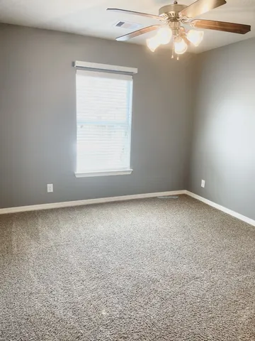 a view of a room with a ceiling fan